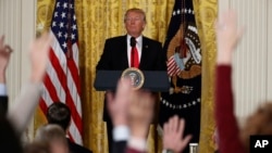 FILE - President Donald Trump looks at reporters during a news conference in the East Room of the White House in Washington, Feb. 16, 2017. 