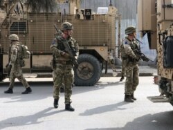 FILE - British soldiers with the NATO-led Resolute Support Mission arrive at the site of an attack in Kabul, Afghanistan, March 6, 2020.
