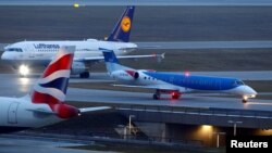 FILE - A British Midland Airways (bmi) aircraft, a plane by Lufthansa and an airplane of the British Airways are seen at the international airport in Munich, Germany, Jan. 9, 2018. 