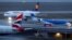 FILE - A British Midland Airways (bmi) aircraft, a plane by Lufthansa and an airplane of the British Airways are seen at the international airport in Munich, Germany, Jan. 9, 2018. 