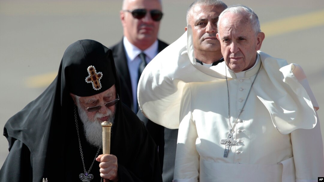 Pope Francis (R) walks with Georgian Orthodox Patriarch Ilia II after landing in Tbilisi, Georgia, Sept. 30, 2016.