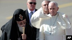 Pope Francis (R) walks with Georgian Orthodox Patriarch Ilia II after landing in Tbilisi, Georgia, Sept. 30, 2016.