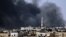 Smoke rises over the Salah al-Din neighborhood in central Aleppo during clashes between Free Syrian Army fighters and Syrian Army soldiers, August 4, 2012. 