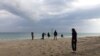 Team shooting with migrants on Stignano beach, Calabria, Italy. 