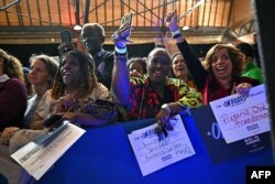 FILE—Supporters of US President Joe Biden hold signs as he speaks during a campaign event in Atlanta, Georgia, on March 9, 2024.