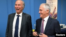 Conservative Liberal party MP John Alexander laughs as he stands with Australian Prime Minister Malcolm Turnbull during a visit to a printing company in Sydney, Australia, April 4, 2017.