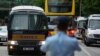 A prison van, left, which a police officer says is carrying Tong Ying-kit arrives at a court in Hong Kong, June 23, 2021. 