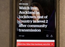 A news alert is displayed on a mobile phone in Christchurch, New Zealand, Aug. 11, 2020.