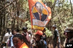 FILE - Supporters of the incumbent Madagascar President Andry Rajoelina, attend the first meeting of his electoral campaign, in Antananarivo, on October 10, 2023.