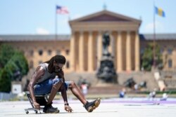 Philadelphia mural artist Felix St. Fort lays out a grid for his creation to be painted on the ground at Eakins Oval in Philadelphia, June 28, 2021. The work titled "Welcome Back, Philly" was expected to be completed ahead of July 4 celebrations.