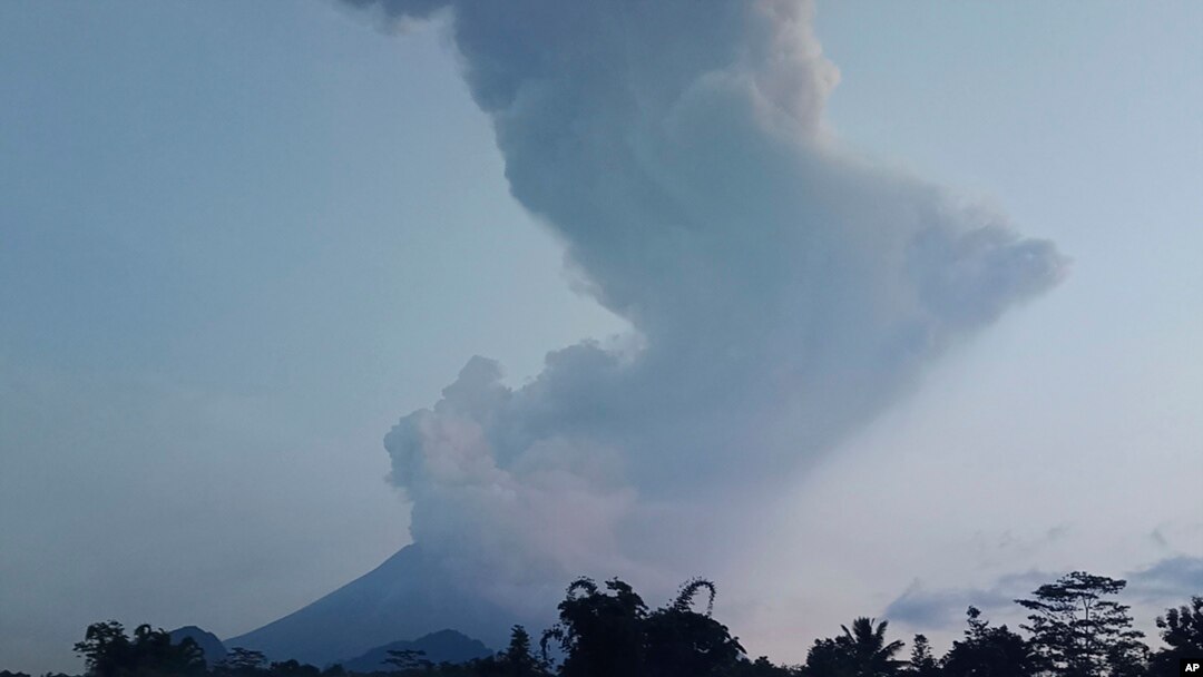 Mount Merapi spews volcanic material into the air in Sleman, Indonesia, Tuesday, March 3, 2020. Indonesia's most active volcano erupted Tuesday, spewing sand and pyroclastic material and sending massive smoke-and-ash column into the sky.