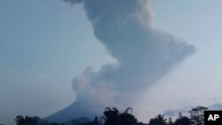 Mount Merapi spews volcanic material into the air in Sleman, Indonesia, Tuesday, March 3, 2020. Indonesia's most active volcano erupted Tuesday, spewing sand and pyroclastic material and sending massive smoke-and-ash column into the sky.