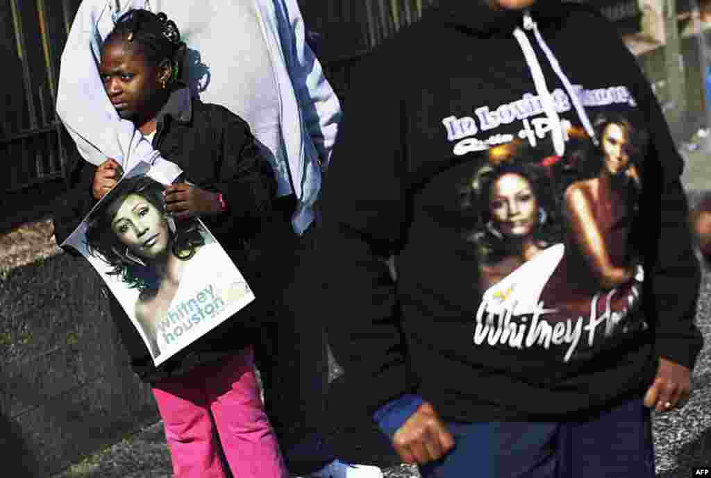 Fans of Whitney Houston stand blocks away from her funeral at Hope Baptist Church in Newark, New Jersey February 18, 2012. (REUTERS)