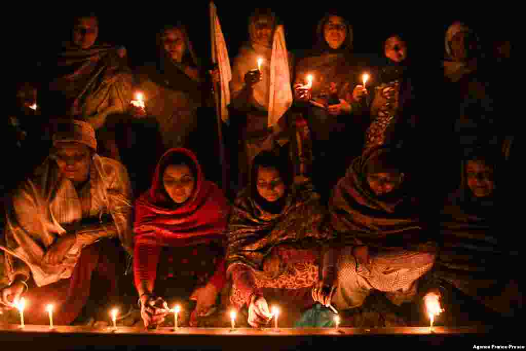 Farmers light candles as they block railway tracks during a demonstration demanding compensations and jobs for the families of those who died during protests against the central government&#39;s agricultural reforms and other economic issues at Devi Dasspura 