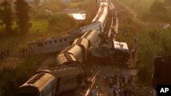 Cars from two passenger trains lie off the tracks after they collided just outside Egypt's Mediterranean port city of Alexandria, Aug. 11, 2017.