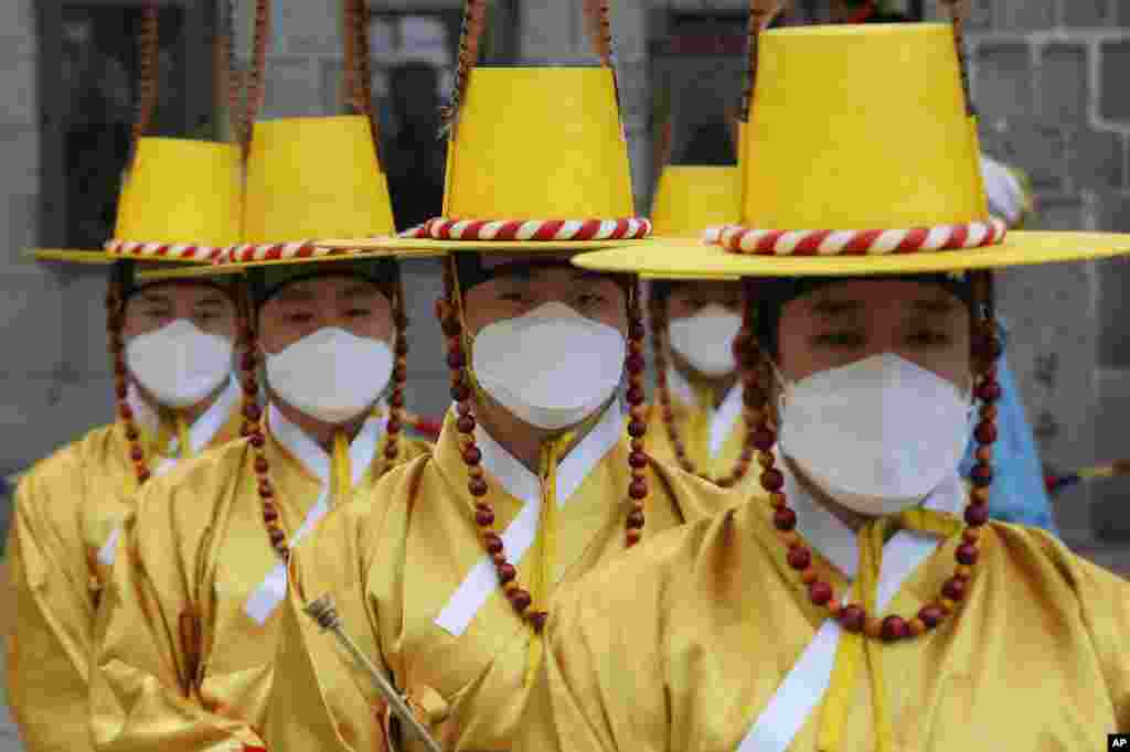 Imperial guards wear protective face masks during a reenactment of the Royal Guards Changing Ceremony in front of Deoksu Palace in Seoul, South Korea.