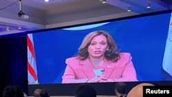 U.S. Vice President Kamala Harris speaks remotely on a video screen during the Pacific Islands Forum