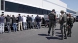 U.S. Immigration and Customs Enforcement, Asian workers are seen shackled and getting onto a bus after an ICE raid on a Hyundai Motor car battery facility in Georgia, Sept. 4, 2025.