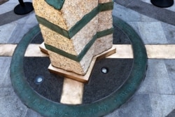 Inscriptions ring the base of two of the stone pillars completed Aug. 19, 2019, in Boston to memorialize the Boston Marathon bombing victims at the sites where they were killed.