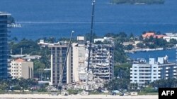 Cranes are seen at a partially collapsed building in Surfside, Florida, north of Miami Beach, on June 27, 2021.