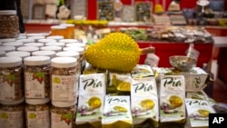 FILE: A reproduction of a durian sits atop packages of durian cakes from Vietnam at a "Belt and Road Products New Year's Marketplace" at a shopping mall in Beijing, Jan. 10, 2020. 