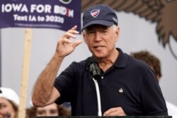 Democratic presidential candidate and former Vice President Joe Biden puts on a Beau Biden Foundation hat while speaking at the Polk County Democrats Steak Fry, in Des Moines, Iowa, Sept. 21, 2019.