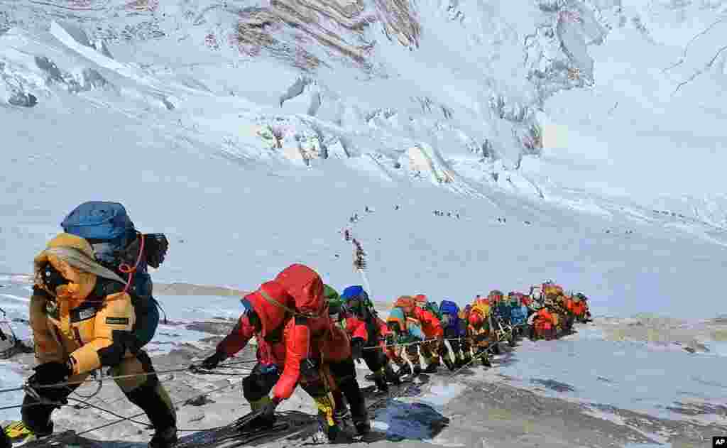 A long queue of mountain climbers line a path on Mount Everest just below camp four, in Nepal. Seasoned mountaineers say the government&#39;s failure to limit the number of climbers on Mount Everest has resulted in dangerous overcrowding and a greater number of deaths.