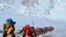 In this May 22, 2019 photo, a long queue of mountain climbers line a path on Mount Everest just below camp four, in Nepal that has now suspended climbing permits due to concern over the spread of the coronavirus