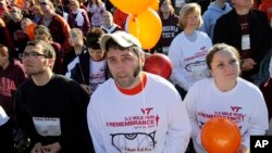 FILE -Virginia Tech student Kevin Sterne, who was injured in the Virginia Tech shooting two years ago, looks up at balloons released in remembrance of the victims of the 2007 Virginia Tech shootings, April 16, 2009.