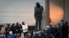 Daughter Rosanne Cash, center left, accompanied by other family members, looks up during the unveiling of a bronze statue of American singer-songwriter Johnny Cash, in Emancipation Hall at the Capitol in Washington, Sept. 24, 2024.