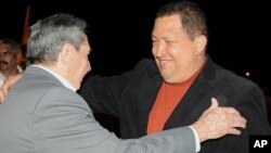 In this photo released by Cuba's state-run Granma newspaper, Cuba's President Raul Castro, left, welcomes Venezuela's President Hugo Chavez upon his arrival to Havana, Cuba, Friday Feb. 24, 2012. Chavez arrived in Cuba for urgent surgery to remove a tumor