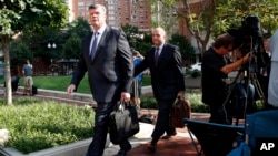 Kevin Downing, left, and Thomas Zehnle, the attorneys for Paul Manafort, arrive for the trial of former Trump campaign chairman Paul Manafort as it continues in federal court in Alexandria, Va., Tuesday, Aug. 7, 2018.