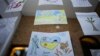 Children's drawings, the bottom one reading "Ukraine in the Heart" are presented at a UNICEF organized exhibition of drawings by Ukrainian refugee children and Romanian children in Bucharest, Romania, Jan. 31, 2023. 