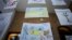 Children's drawings, the bottom one reading "Ukraine in the Heart" are presented at a UNICEF organized exhibition of drawings by Ukrainian refugee children and Romanian children in Bucharest, Romania, Jan. 31, 2023. 