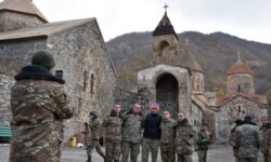 FILE - Armenian soldiers pose for a photo near the 12th-13th century Orthodox Dadivank Monastery on the outskirts of Kalbajar on November 18, 2020.