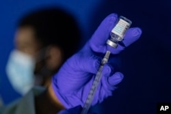 FILE - Family nurse practitioner prepares a syringe with the Mpox vaccine before inoculating a patient at a vaccinations site on Augist 30, 2022, in the Brooklyn borough of New York.