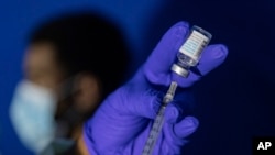 FILE - Family nurse practitioner Carol Ramsubhag-Carela prepares a syringe with the Mpox vaccine before inoculating a patient at a vaccinations site on in Brooklyn, New York on Aug. 30, 2022. 