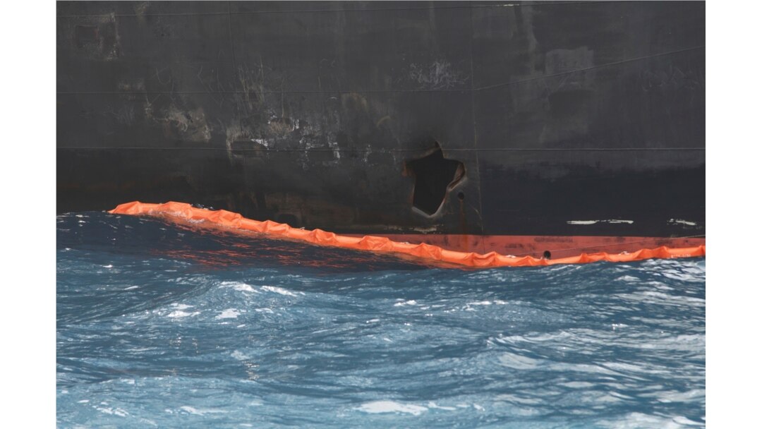 A hole the U.S. Navy says was made by a limpet mine is seen on the damaged Panama-flagged, Japanese owned oil tanker Kokuka Courageous, anchored off Fujairah, UAE, during a trip organized by the Navy for journalists, June 18, 2019.