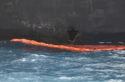 A hole the U.S. Navy says was made by a limpet mine is seen on the damaged Japanese owned oil tanker Kokuka Courageous, anchored off Fujairah, UAE, during a trip organized by the Navy for journalists, June 19, 2019.