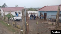 Police officials work at the scene of a mass shooting in Lusikisiki