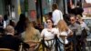 FILE - People relax at outdoor dining areas on the South Bank, as lockdown restrictions continue to ease amid the spread of the coronavirus disease, in London, May 28, 2021. 