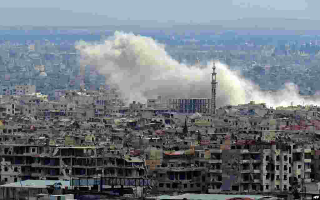 A general view taken from a government-held area in Damascus shows smoke rising from the rebel-held enclave of Eastern Ghouta on the outskirts of the Syrian capital following fresh airstrikes.