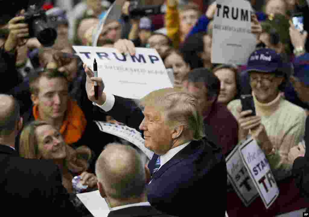 Republican presidential candidate, billionaire Donald Trump, gestures to the crowd as he signs autographs at a campaign event at Plymouth State University Sunday, Feb. 7, 2016, in Plymouth, New Hampshire.