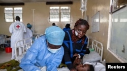 A health worker attends to a newly-admitted patient with a suspected bullet wound at the CBCA Ndosho hospital in the town of Sake, near Goma in eastern Democratic Republic of Congo,&nbsp;<br />
following the intense fighting between M23 rebels and the Armed Forces of the Democratic Republic of the Congo.