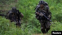 Japanese soldiers train during a joint military drill between Japan Self-Defense Forces, French Army and U.S. Marines, at the Kirishima exercise area in Ebino, Miyazaki prefecture, Japan May 15, 2021. Charly Triballeau/Pool via REUTERS