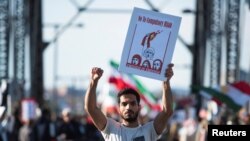 A protestor holds a banner during a protest in support of women in Iran