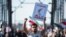 A protestor holds a banner during a protest in support of women in Iran