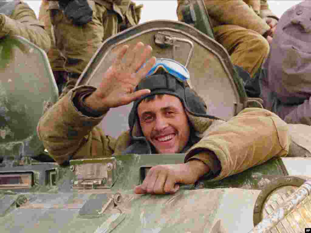 A smile and a wave from a happy Soviet soldier, as his armored convoy makes its way back to the Soviet Union along a north Afghanistan highway in this Sunday, Feb. 7, 1989, file photo. The Soviet Union lost some 15,000 soldiers in the war, which began in 