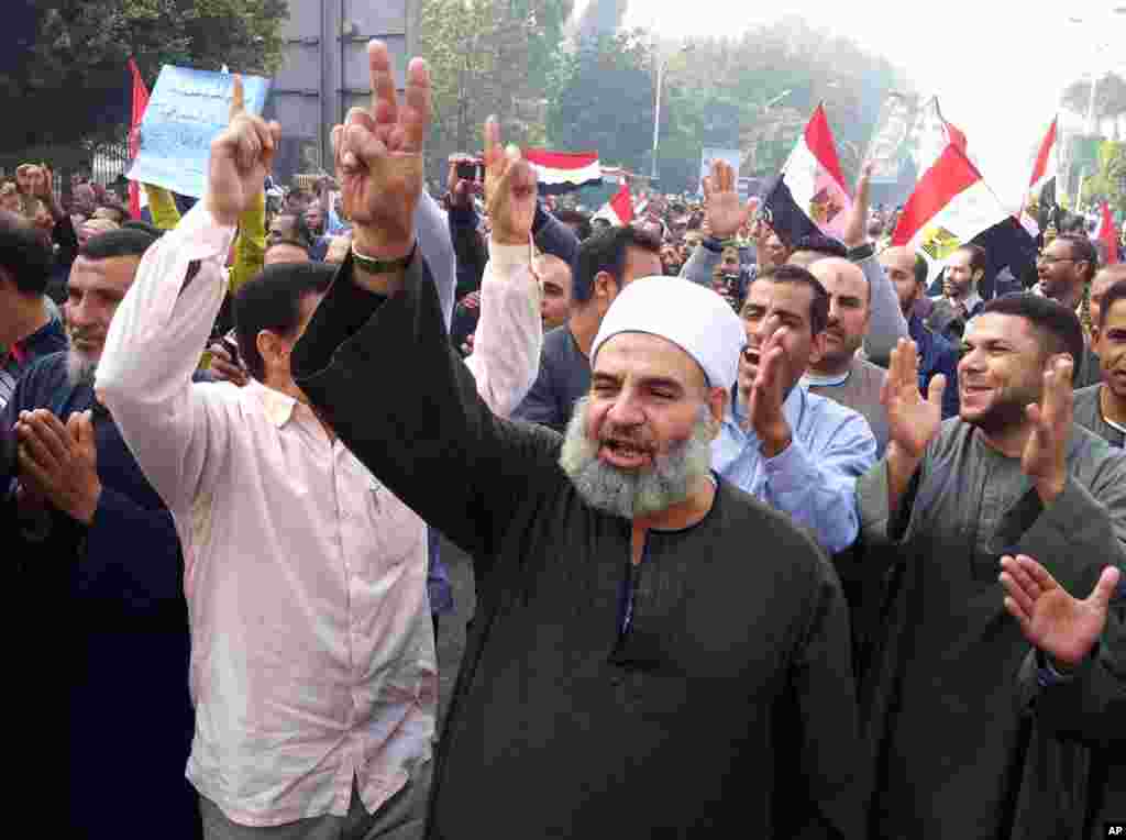 In this image made with a mobile phone camera, supporters of Egyptian President Mohammed Morsi march in Cairo, Egypt, Saturday, Dec. 1, 2012.