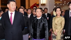 This handout picture released by Myanmar News Agency (MNA) on January 18,2020 and taken on January 17, 2020, shows Chinese President Xi Jinping (L), Myanmar President Win Myint (C) and Myanmar State Counsellor Aung San Suu Kyi (R), attending a cermony mar